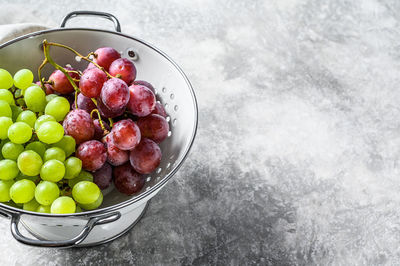 High angle view of grapes in bowl on table
