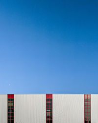 Low angle view of building against clear blue sky