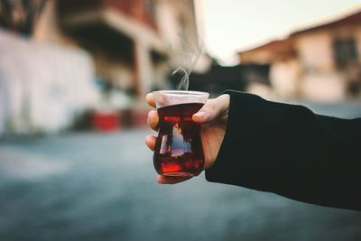 Close-up of hand holding wine glass
