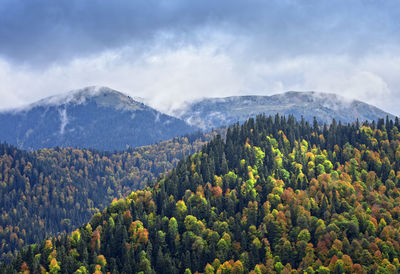 Scenic view of mountains against cloudy sky