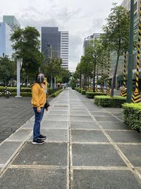 Full length rear view of man walking in city