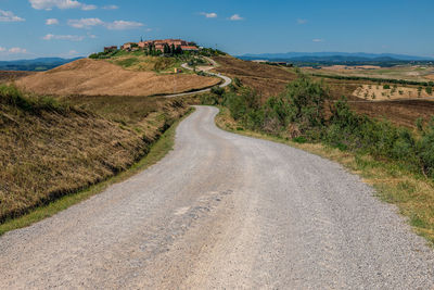View of the road leading to mucigliani village - small place surrounded by agricultural landscapes.