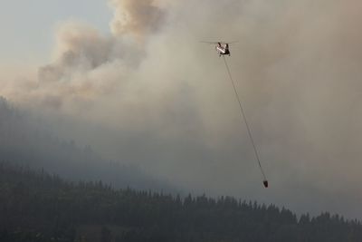 Low angle view of helicopter flying in sky