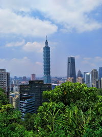 View of skyscrapers against cloudy sky