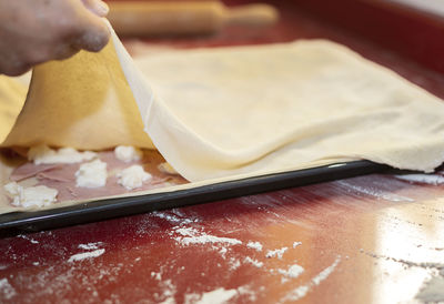 Midsection of person preparing food on table