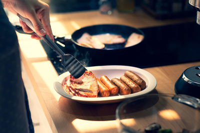 Midsection of person preparing food in kitchen