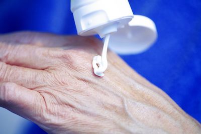 Close-up of hand holding blue ring