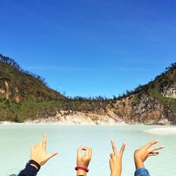 Scenic view of sea with mountain in background
