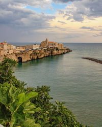 Scenic view of sea and buildings against sky