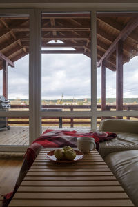 Apples and coffee cup on table at home