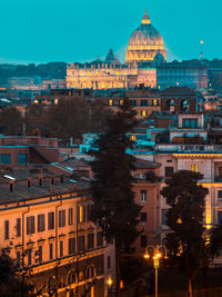 Illuminated buildings in city at dusk in rome