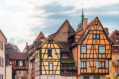 Low angle view of houses and buildings against sky