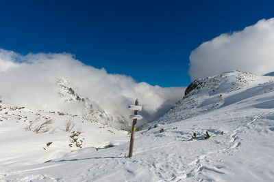 Scenic view of snow covered mountains against sky