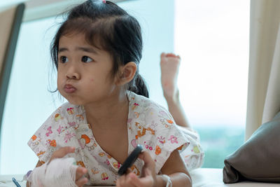 Portrait of cute girl looking at home