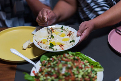 People eat together. a table set with delicacies from the arab cuisine. chickpeas, salads, pitas