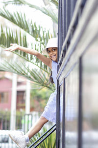 Portrait of woman looking through railing