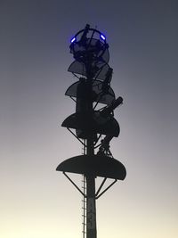 Low angle view of communications tower against sky