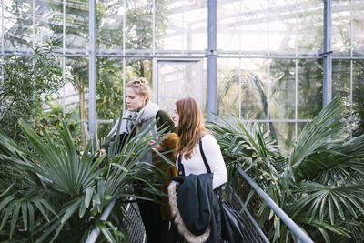 Woman standing in greenhouse