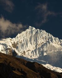 Low angle view of snowcapped mountain against sky