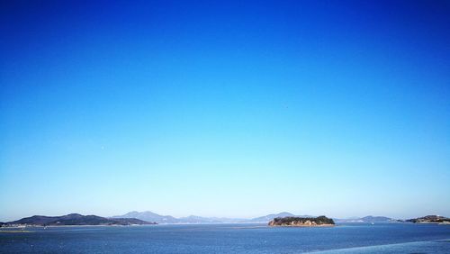 Scenic view of sea against clear blue sky