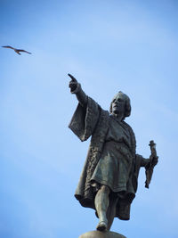 Low angle view of statue against sky