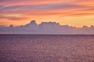 Scenic view of sea against orange sky