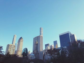 Low angle view of buildings against clear blue sky