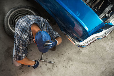 Low section of man cleaning car