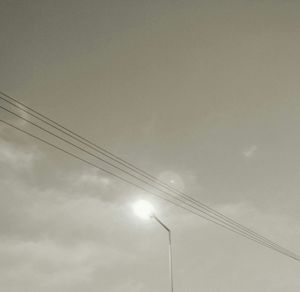 Low angle view of electricity pylon against sky