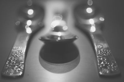 Close-up of illuminated candles on table