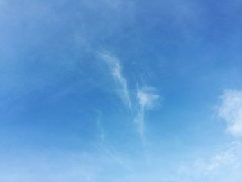 Low angle view of vapor trail in blue sky