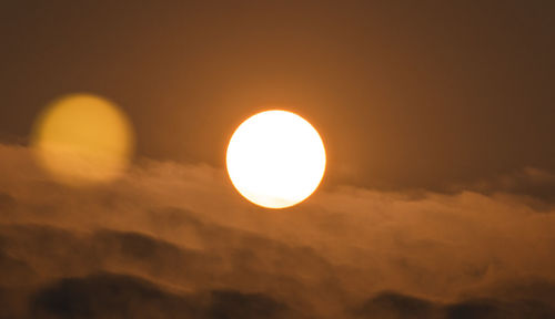 Low angle view of sun against sky during sunset