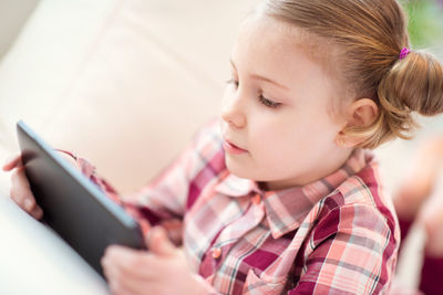 Close-up of girl using digital tablet