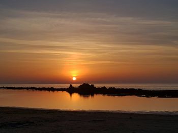 Scenic view of sea against romantic sky at sunset