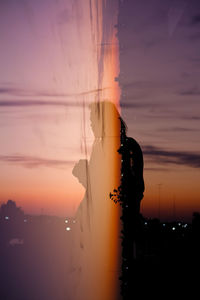 Double exposure of man and sunset view skyline night lights