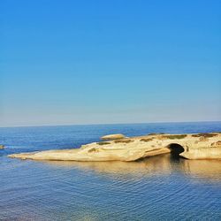 Scenic view of sea against clear blue sky