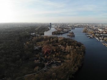 High angle view of buildings by sea against sky