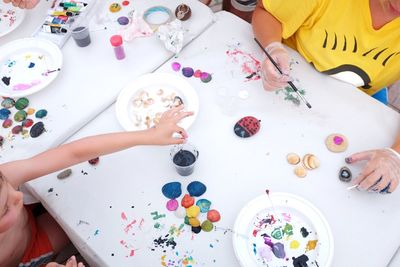 High angle view of child playing on table