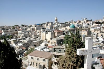 Buildings in city against clear sky