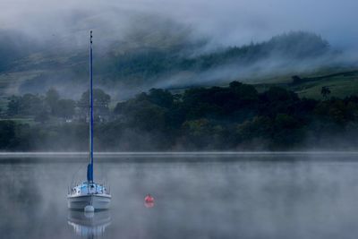 Scenic view of lake during foggy weather