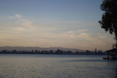 Scenic view of lake against sky during sunset