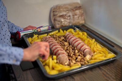 Roasted meat and potatoes in baking dish prepared for festive dinner
