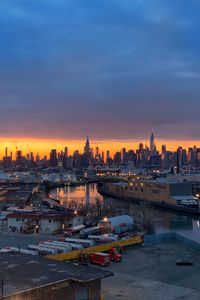 City at waterfront during sunset