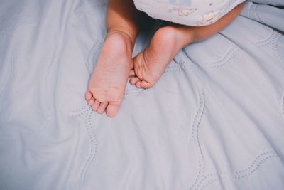 Low section of woman on bed