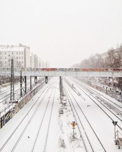 Railroad tracks against sky during winter