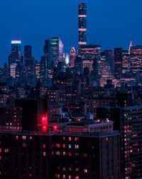 Illuminated cityscape against clear sky at night