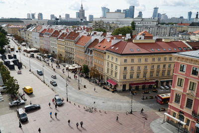 High angle view of people on street amidst buildings in city