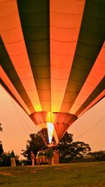 Illuminated hot air balloon against sky at sunset