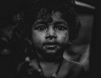 Close-up portrait of boy with dirty face