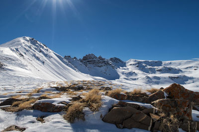 Scenic view of snowcapped mountains against clear sky at night